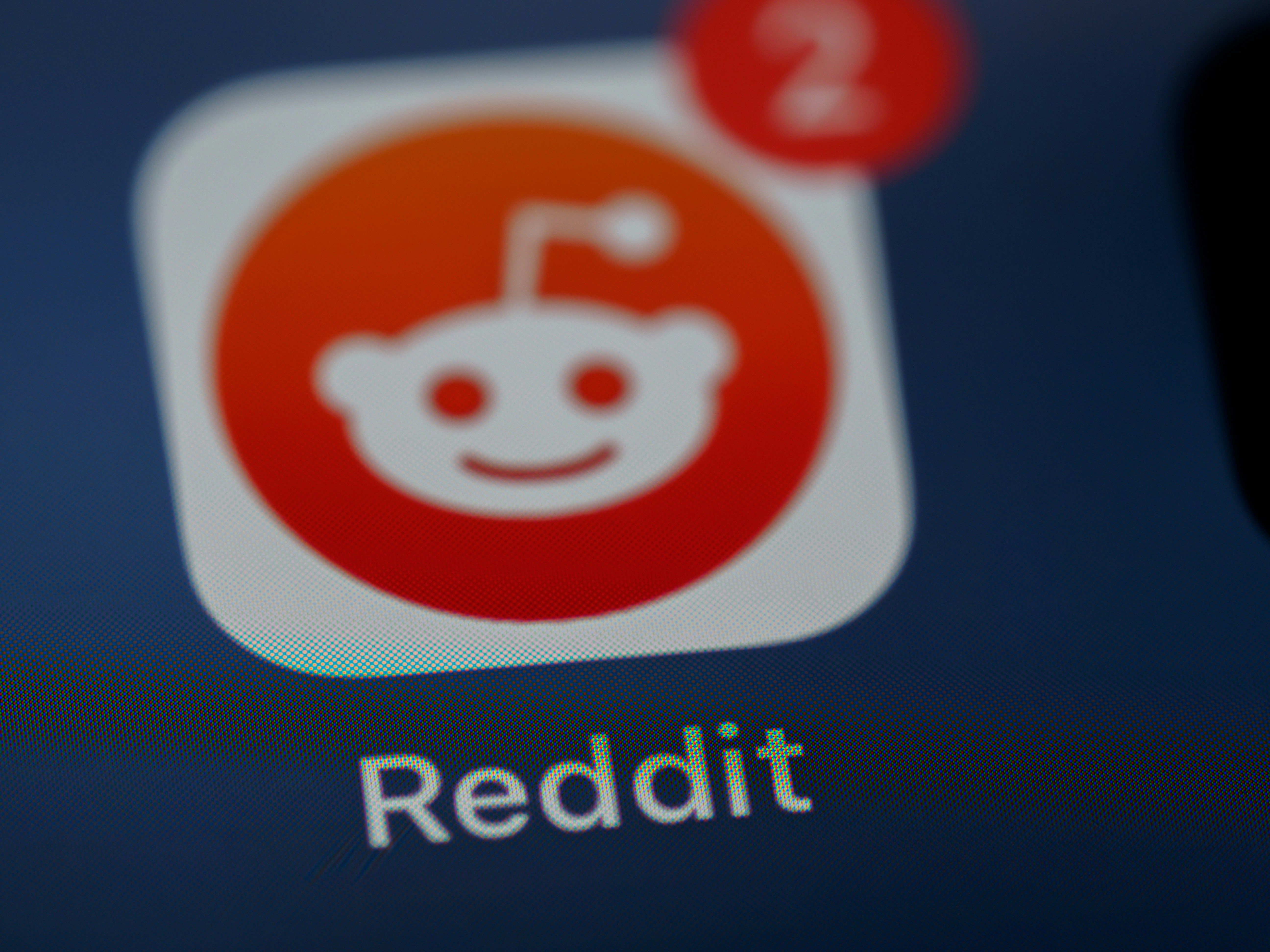 Reddit app visible inside a smartphone screen