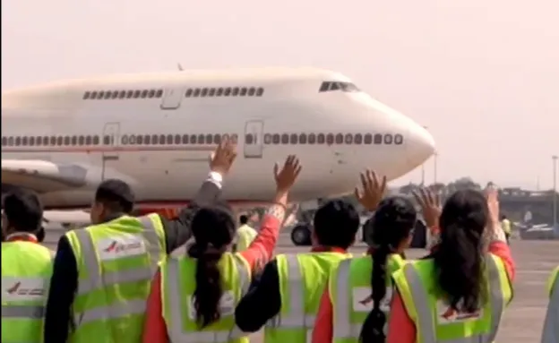 The aircraft took off for its new home in the US at 10:47 am. Air India stuff waiving goodbye at the Mumbai airport (Image: X/Air India)